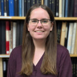 A photo of Laura in front of books.